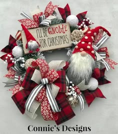 a christmas wreath with santa claus and other holiday decorations on the front door for someone's home