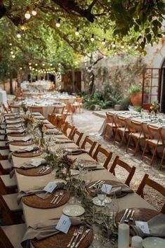 an outdoor dining area with tables and chairs set up for a formal dinner or party