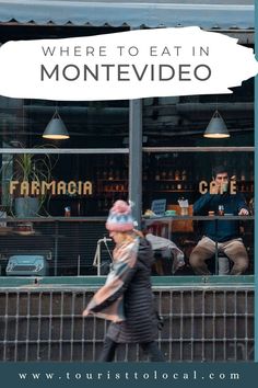 a woman walking past a store front with the words where to eat in montevideo