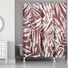 a shower curtain with red and white leaves on it