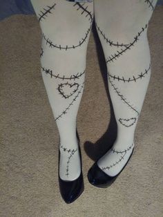 the legs of a person wearing white tights with barbed wire on them