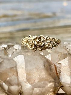 "The Rose Tendril ring is intricately detailed with a trinity of roses, leaves and vines wrapping around the band. (A few thorns are woven into the design for good measure.) The ring is 5/8\" wide and is lost wax cast in solid 14K gold. This graceful ring is a perfect every day ring, commitment ring or wedding ring. The ring is an unbroken circle and a symbol of eternity and commitment. It is likely that we will need to custom make this ring in your size. We will contact you to let you know if w Elegant 14k Gold Flower Ring With Rose Design, Elegant 14k Gold Rose Design Ring, Rose Flower 14k Gold Anniversary Ring, 14k Gold Rose Design Ring, Elegant Gold Rings With Rose Details, Gold Promise Rings With Rose Design, Elegant Yellow Gold Ring With Rose Design, Yellow Gold Flower Ring With Rose Design For Anniversary, Yellow Gold Jewelry With Roses For Wedding