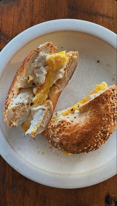 an open sandwich on a white plate with sesame sprinkles and orange slices