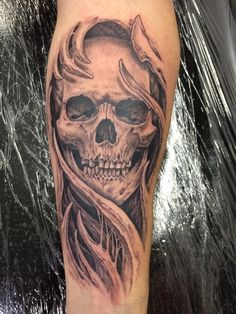 a man's leg with a skull tattoo on it