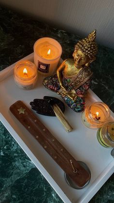 candles, figurines and other decorative items on a tray