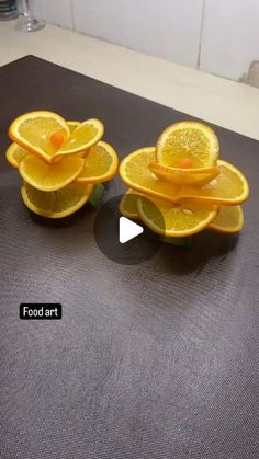 three oranges are stacked on top of each other in the shape of flower petals