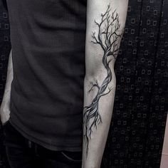 a man with a tree tattoo on his arm