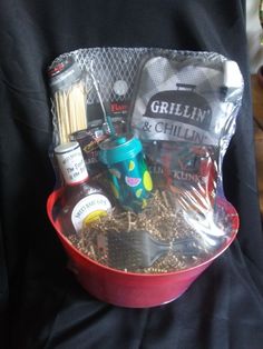 a red bowl filled with food and condiments on top of a black cloth