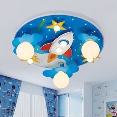 a child's bedroom with a rocket ship ceiling light