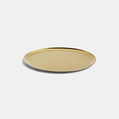 an oval gold plate on a white background