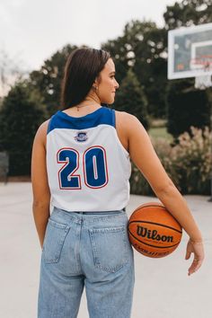 a woman holding a basketball in her right hand