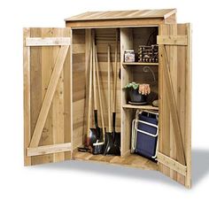 an open wooden storage shed with gardening tools in the door and shelves on either side