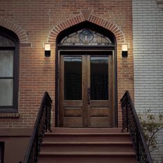 an entrance to a brick building with two doors