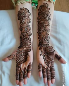 two hands with henna designs on them