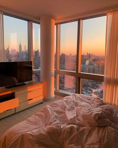 a bedroom with a large window overlooking the city