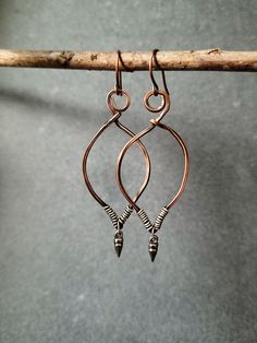 Copper wire hoop earrings, hammered and given a beautiful patina.  Silver wire wraps the bottom where a mini silver spike hangs. These drop about 2.5" from the top of the ear wire. I've added a clear coating to protect from further oxidation. Care suggestions: - Remove your jewelry before showering, sleeping, swimming or sweating. - Most pieces, unless otherwise specified, can be cleaned with a mild dish soap and soft toothbrush if really necessary. Do NOT soak your jewelry or use any chemicals. - Clean your jewelry before and after each use with a soft dry polishing cloth.  I do accept returns, exchanges, and cancellations. Contact me within 14 days of delivery Ship items back within 30 days of delivery Request a cancellation within 2 days of purchase. If you have any questions, please us Hammered Wire Jewelry Diy, Wire Earrings Diy, Hammered Wire Jewelry, Copper Jewelry Diy, Copper Earrings Handmade, Wire Jewelry Earrings, Wire Jewelry Rings, Wire Hoop Earrings, Handmade Jewlery