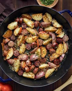 a pan filled with cooked potatoes and sausage