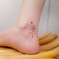 a small tattoo on the foot of a woman