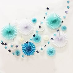 blue and white paper fans are arranged on the wall, with stars in the background