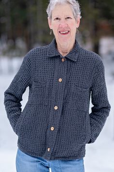 an older woman standing in the snow with her hands on her hips