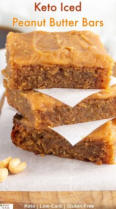 A stack of  keto iced peanut butter bars with coffee in the background. Keto Reeses Bars, Keto Peanut Butter Squares, Keto Peanut Butter Desserts Easy, Keto Recipes With Peanut Butter, Peanut Butter Low Carb Dessert, Low Carb Peanut Butter Bars, Keto Peanut Butter Bars No Bake, Bariatric Peanut Butter Recipes, Keto Salted Caramel Butter Bars