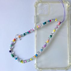 a phone case with a colorful beaded lanyard on it