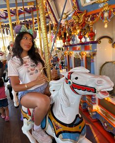 a woman sitting on top of a merry go round