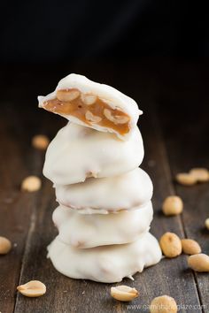 a stack of cookies with white frosting and nuts