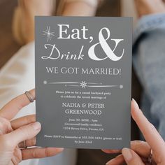 two people holding up a card with the words eat, drink and we got married