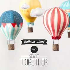 three hot air balloons are hanging from strings with the words balloon - along let's sew it together