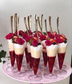 there are many desserts with strawberries in them on the cake platter,