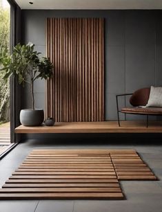 a wooden bench sitting in the middle of a living room next to a planter