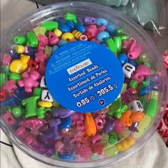 a plastic container filled with lots of colorful beads