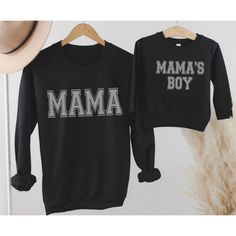 The Cutest matching Mommy and Son shirts.  Mama and Mama's Boy t-shirt or sweatshirt in 3 Colors. Soft and Comfy our Unisex Sized Sweatshirts are sure to be a favorite.   TO PLACE YOUR ORDER: 1. Select your size/style and color from the drop down menus 2. Enter Mama and Mama's Boy Color Preference in Personalization Section: Black, White, Charcoal Gray 3. Click Add to Cart, then go back and repeat for each shirt. Please see images for sizing details. Please measure your current sweatshirts that Black Long Sleeve Sweatshirt With Name Print, Family Matching Graphic Print Sweatshirt, Matching Cotton Sweatshirt For Fall, Cotton Fall Sweatshirt, Black Family Matching Tops For Winter, Cotton Top With Name Print For Winter, Winter Cotton Top With Name Print, Long Sleeve Tops With Letter Print, Family Matching Crew Neck Sweatshirt With Graphic Print