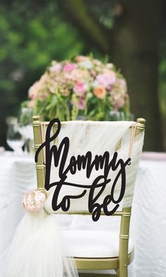 a chair with a sign that says mommy to be