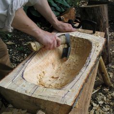 a man is using a hammer to cut wood