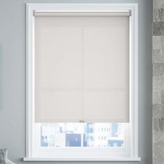 a window with a white blind in front of it