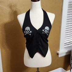 This Is A Cute Black Halter Top Nwot. This Halter Top Has Rhinestone Skull Crossbones Details Size Medium. Black Rock Style Tops For Halloween, Edgy Skull Print Top For Party, Edgy Skull Print Party Tops, Gothic Party Tops With Skull Print, Rock Style Black Party Tops, Rock Style Black Tops For Party, Black Skull Print Rock Top, Black Fitted Rock Style Tops, Halter Top Outfit