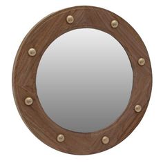 a round mirror with rivets on the side and a wooden frame around it