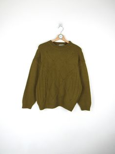 Vintage 90s sweater, green color 70% Wool - 30% Acrylic Made in Italy Size M Measures Shoulder width: 58 cm Sleeve length: 53cm Chest width: 56 cm Length: 66cm Condition: EXCELLENT - Shows signs of wear over time Our garments are all vintage and second hand. Any signs of wear or defects are documented with photos and description. For any questions, photos, videos we are at your disposal.🌈 Green Knit Sweater With Crew Neck, Green Knit Crew Neck Sweater, Cozy Green Textured Knit Sweater, Green Oversized Retro Sweater, Retro Green Winter Tops, Green Retro Winter Tops, Green Crew Neck Sweater For Winter, Olive Crew Neck Sweater For Fall, Vintage Green Sweatshirt For Fall