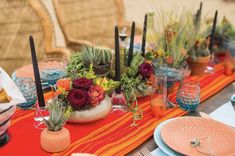 the table is set with many different types of flowers and succulents on it