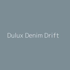 the words dulux denim drift are in white letters on a gray background with an image of