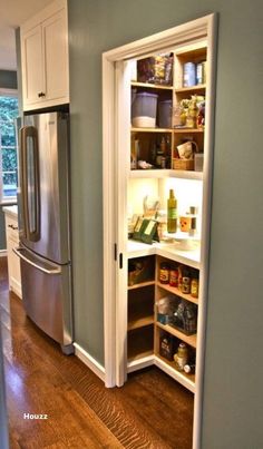 an open pantry in the corner of a kitchen