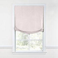 a white window with a beige roman blind