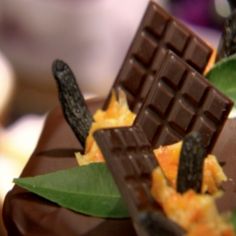 a close up of a chocolate dessert with leaves on it