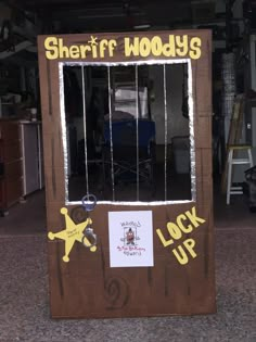 a cardboard door that says sheriff woody's lock up