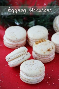 several macaroons are sitting on a red tablecloth with white speckles