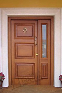 a wooden door with two planters on either side