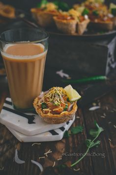 a cup of coffee and some food on a table