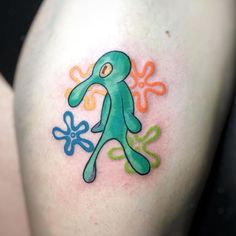 a colorful tattoo on the back of a woman's arm with an image of a person holding a flower